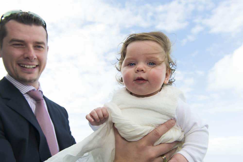 Dad and christening child photographed on balcony of Horizons Function 